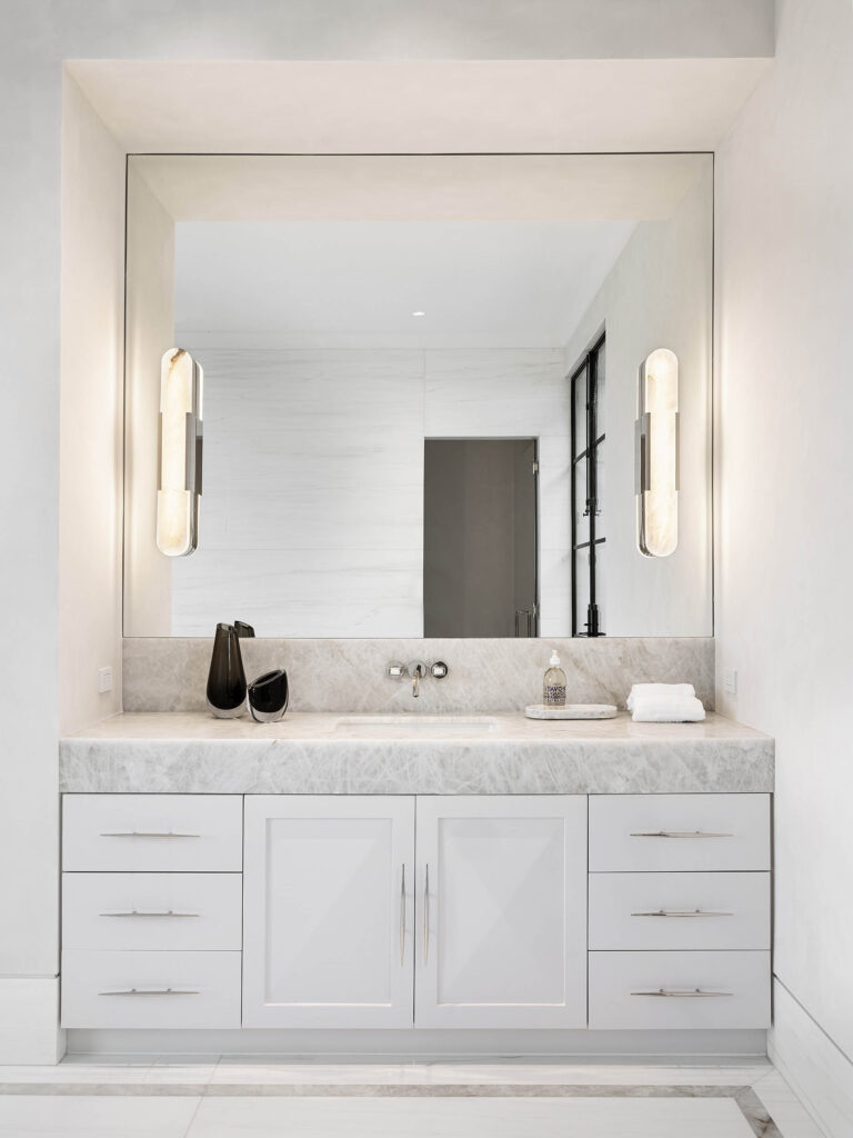 A stylish bathroom from the Birds Street project designed by Coppel Design, featuring modern fixtures, elegant finishes, and large windows that create a bright and luxurious atmosphere.