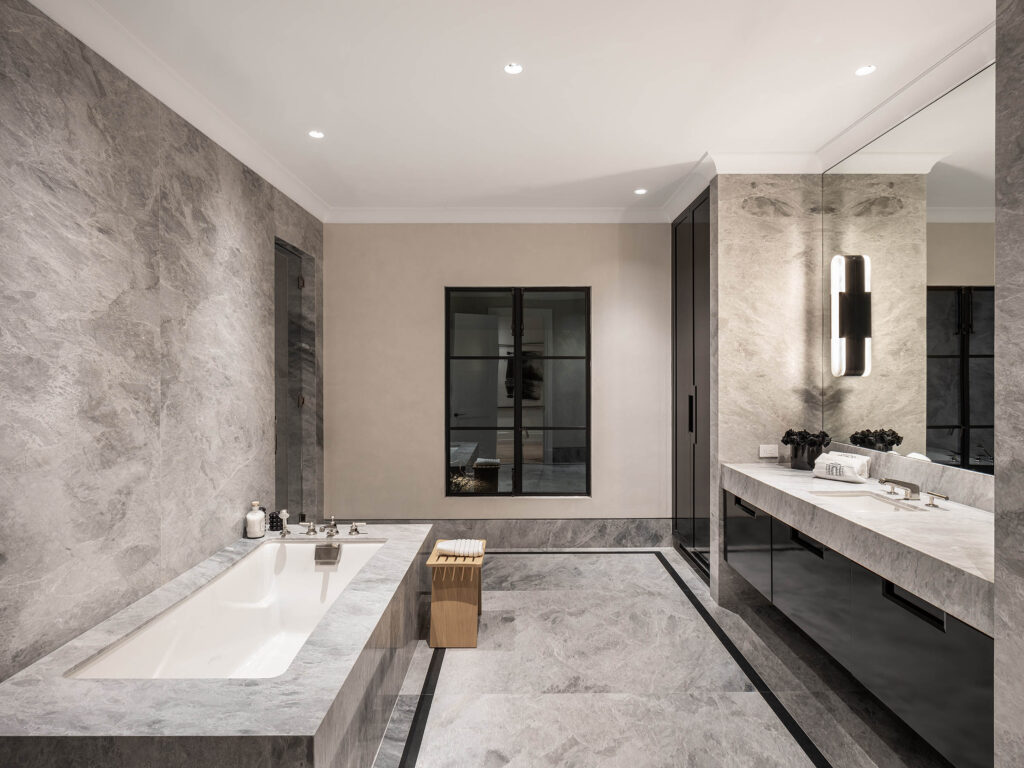 A stylish bathroom designed by Coppel Design for the Birds Street project, featuring modern fixtures, elegant finishes, and large windows that fill the space with natural light.