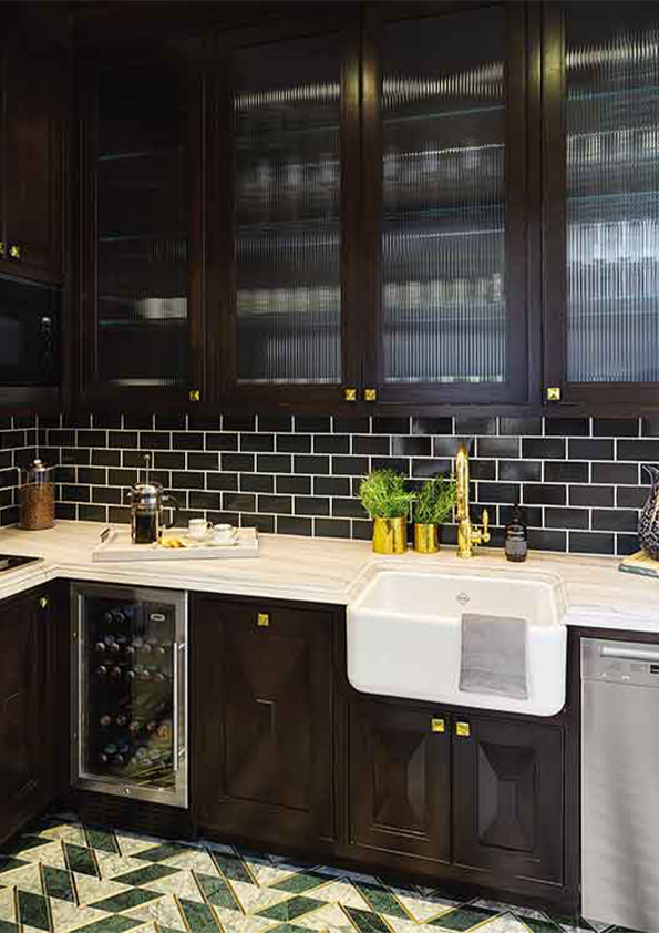 A modern kitchen designed by Coppel Design for the Hombly Hills project, featuring sleek cabinetry, high-end appliances, an expansive island with seating, and large windows that provide abundant natural light.