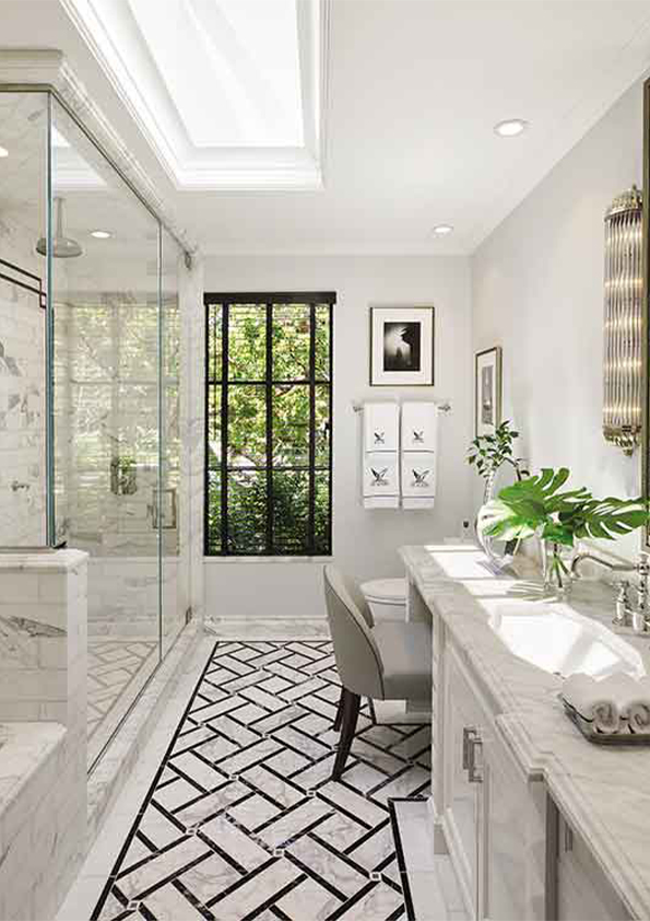 A luxurious bathroom designed by Coppel Design for the Hombly Hills project, featuring elegant marble finishes, a freestanding soaking tub, modern fixtures, and large windows that bring in natural light.